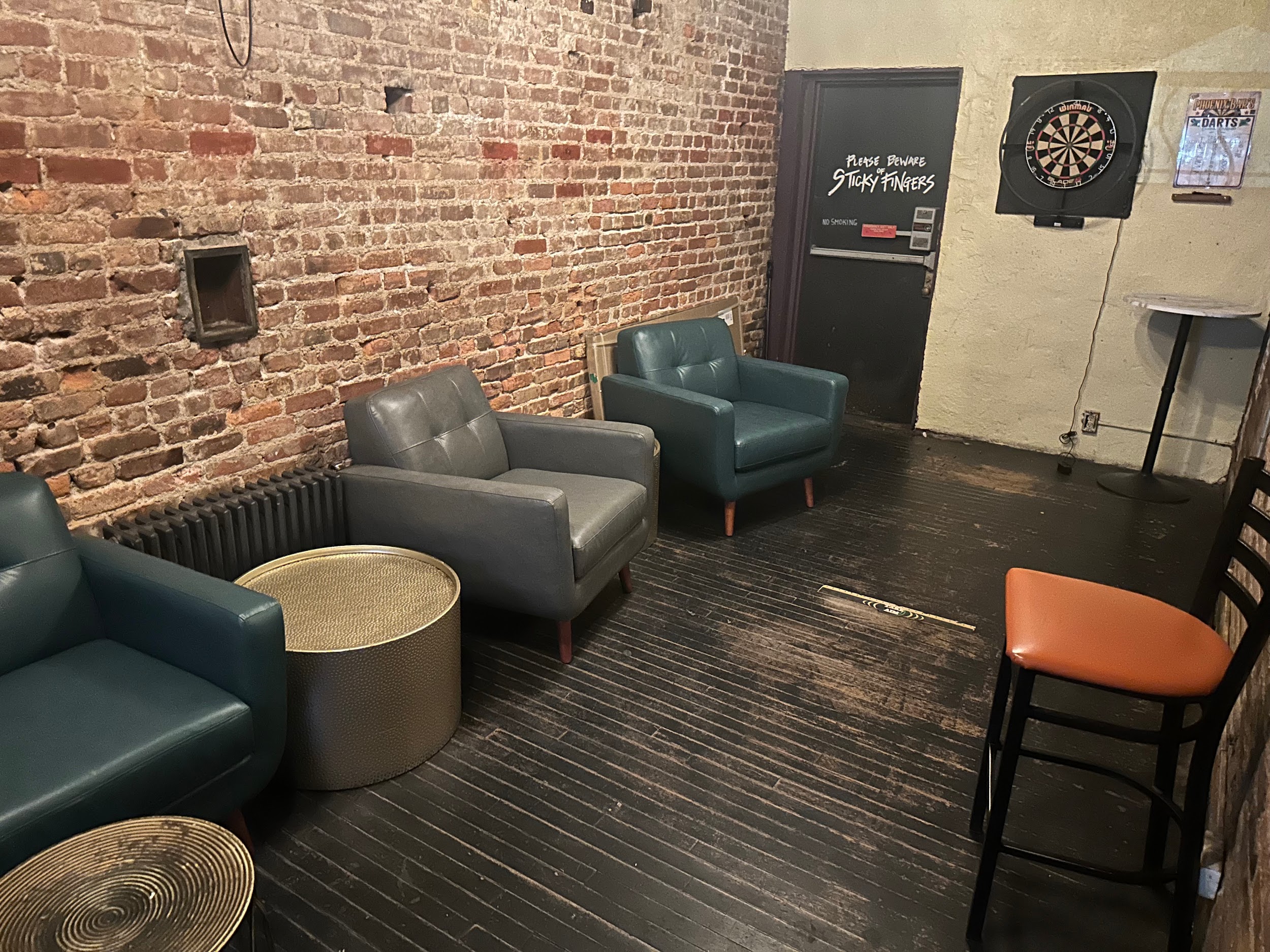 Back lounge seating and darts at Phoenix.